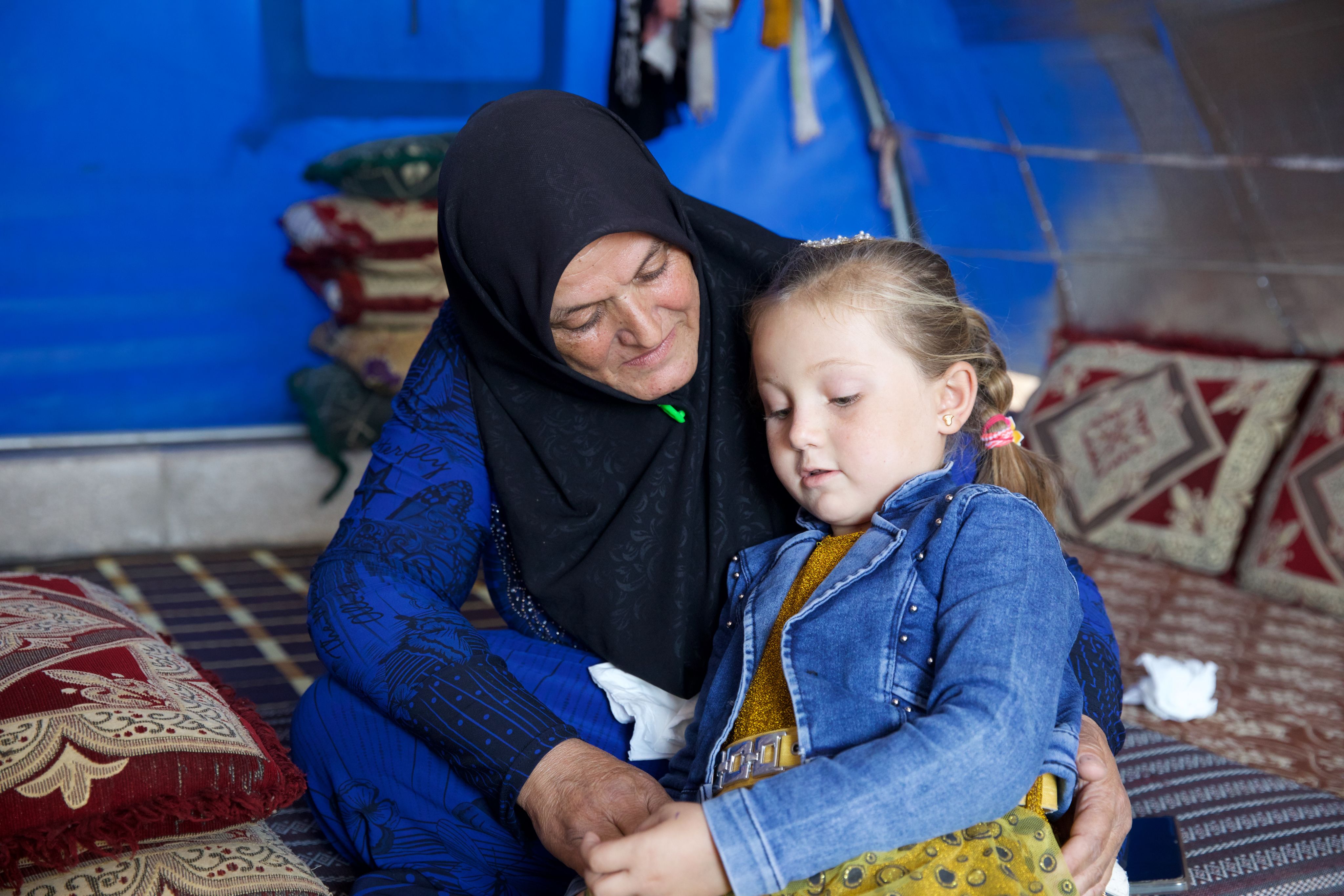green snake on brown branch close-up photo