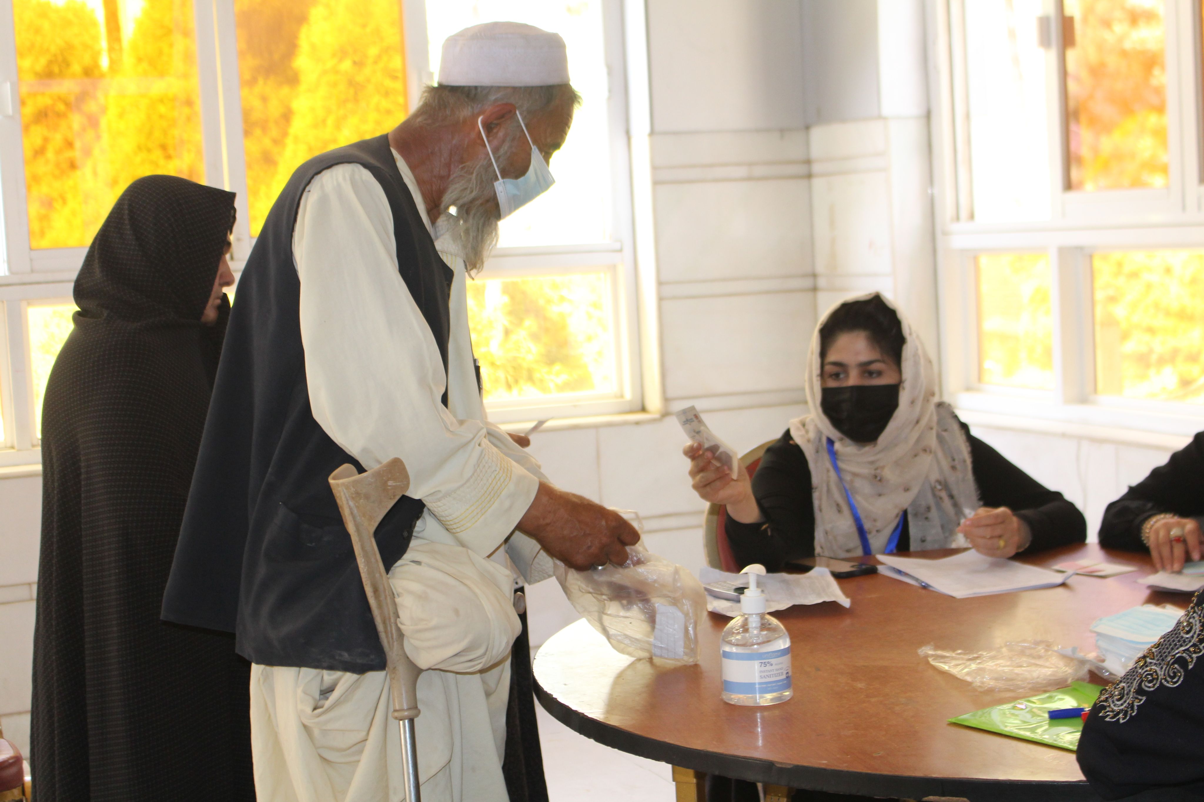 Hesamuddin receives cash in Afghanistan